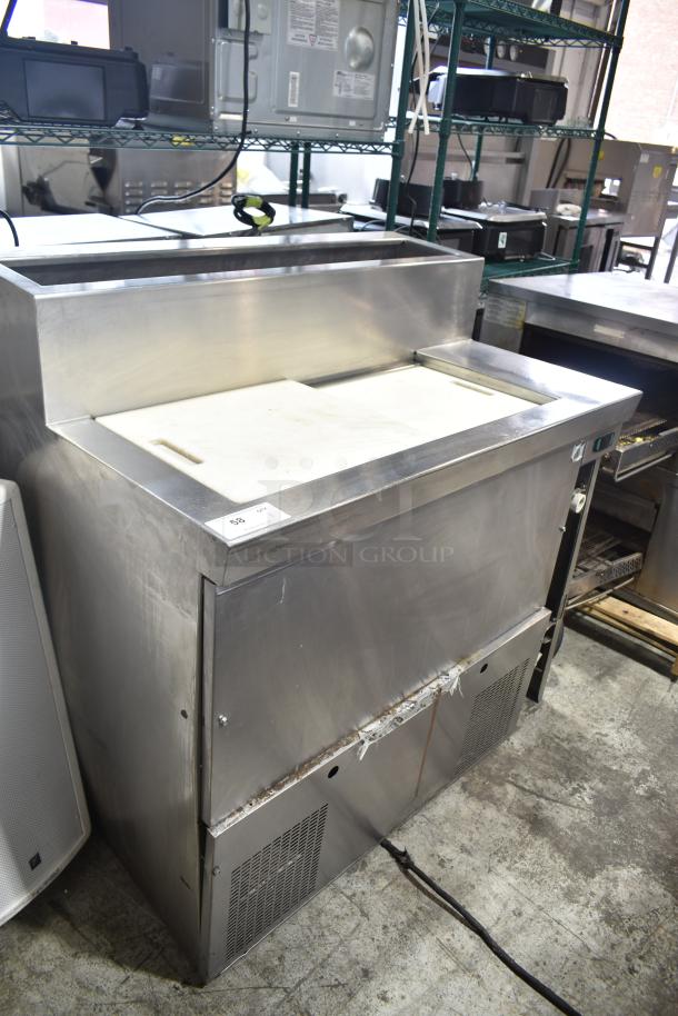 Stainless steel commercial prep table, 115 volts, 1 phase, with cutting board and storage, used condition.