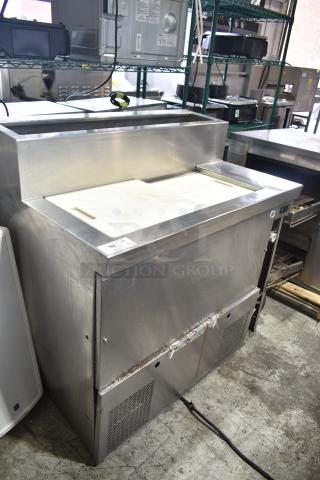 Stainless steel commercial prep table, 115 volts, 1 phase, with cutting board and storage, used condition.