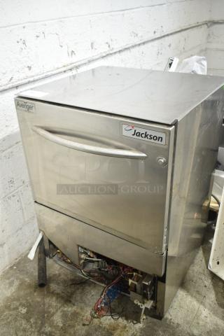 Jackson Avenger undercounter dishwasher, stainless steel, visible wear, labeled "Jackson" and "Avenger".