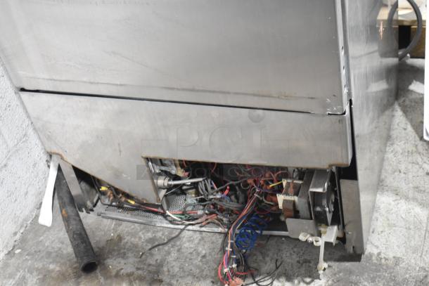 Jackson Avenger Undercounter Dishwasher with exposed wiring and wear, showing interior components and unfinished edges.