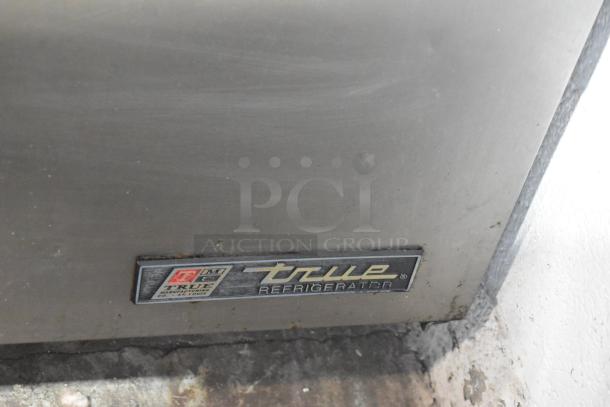 True TSSU-72-30M-B-ST Commercial Prep Table label, showing brand and model details. Surface appears used.