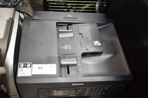 Epson WorkForce WF-7840 printer, scanner, copier machine in good condition; includes control panel and paper guides, with label.