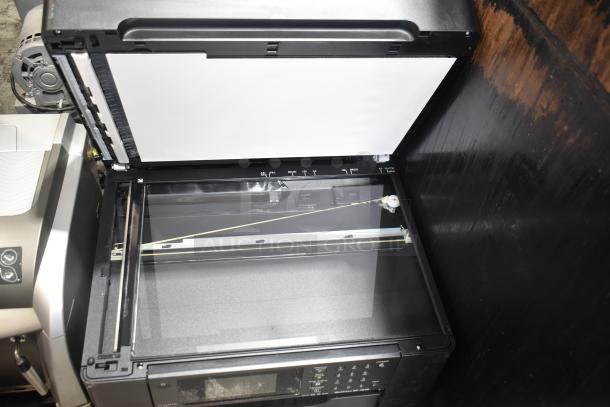 Epson WorkForce WF-7840 multifunction printer with open scanner lid, showing interior glass and control panel details.