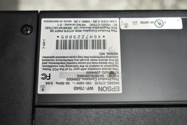 Epson WorkForce WF-7840 label showing model number, FCC IDs, and certification logos on a countertop printer scanner copier.