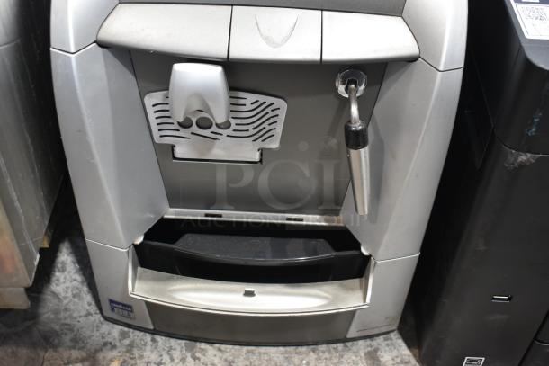 LavAzza countertop espresso machine with steam wand, 115 volts, 1 phase. Silver finish, used condition with visible controls.