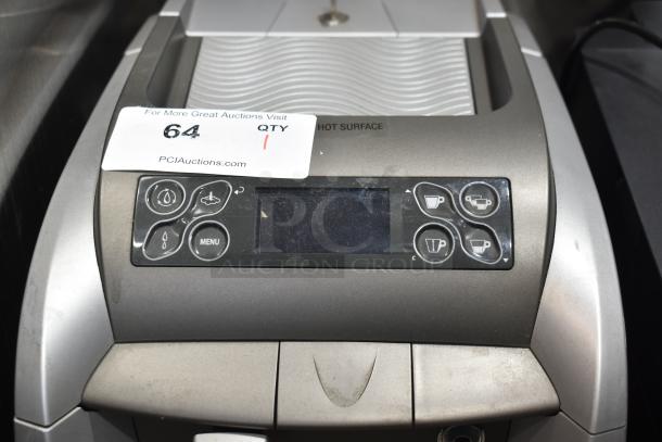 LavAzza countertop espresso machine with steam wand, 115 volts, 1 phase, front control panel, light wear. Auction tag visible.