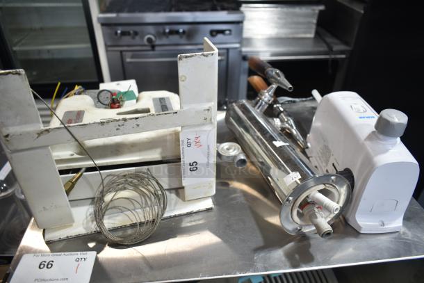 Four items including a beer tower, Ecolab dispenser, fire suppression box, and metal piece on auction. Displayed in used condition.