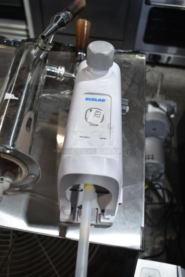 Four auction items including a chrome beer tower, Ecolab dispenser, fire suppression box, and metal piece. Ecolab label visible.