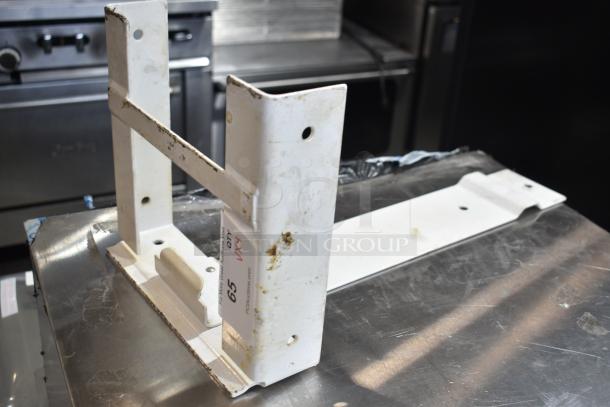 Alt text: White metal bracket, part of auction lot with beer tower, Ecolab dispenser, suppression box, and metal piece. Slight wear visible.