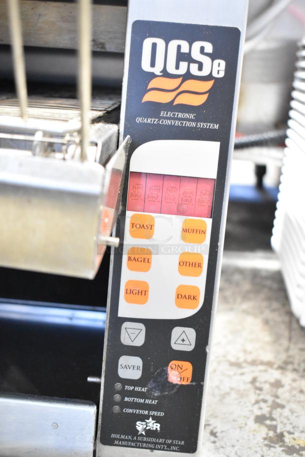 Star Holman QCSE-2-300H conveyor toaster oven, 120V, with control panel featuring toast, muffin, bagel, light, and dark settings.