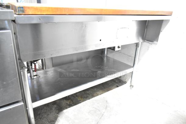 Commercial 3-well steam table with butcher block cutting board, under shelf, stainless steel, used condition.