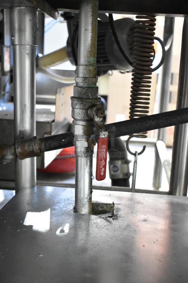 Underside view of Commercial 3 Well Steam Table with metal piping, showing signs of wear. Visible red valve handle.