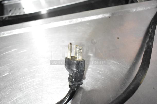 Commercial metal prep table with plug, featuring a True brand design. 115 volts, 1 phase, in good condition.