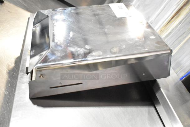 Georgia Pacific stainless steel dispenser, rectangular shape, slight wear visible on surface, wall-mountable.