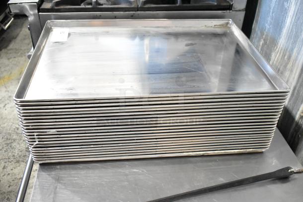 Stack of 21 full-size metal baking pans, lightly used, marked for auction. Ideal for commercial kitchens.