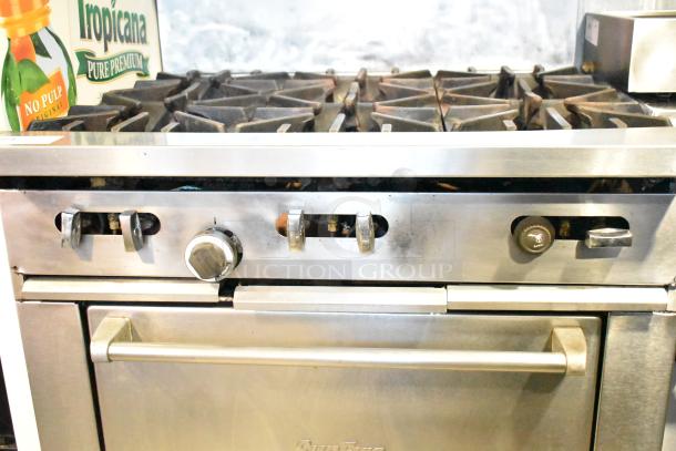 Garland SunFire commercial 6-burner gas range with oven, over shelf, backsplash; features stainless knobs; on commercial casters.