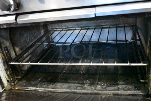 Garland SunFire commercial oven interior; shows rack and worn metal surfaces, indicating moderate use.
