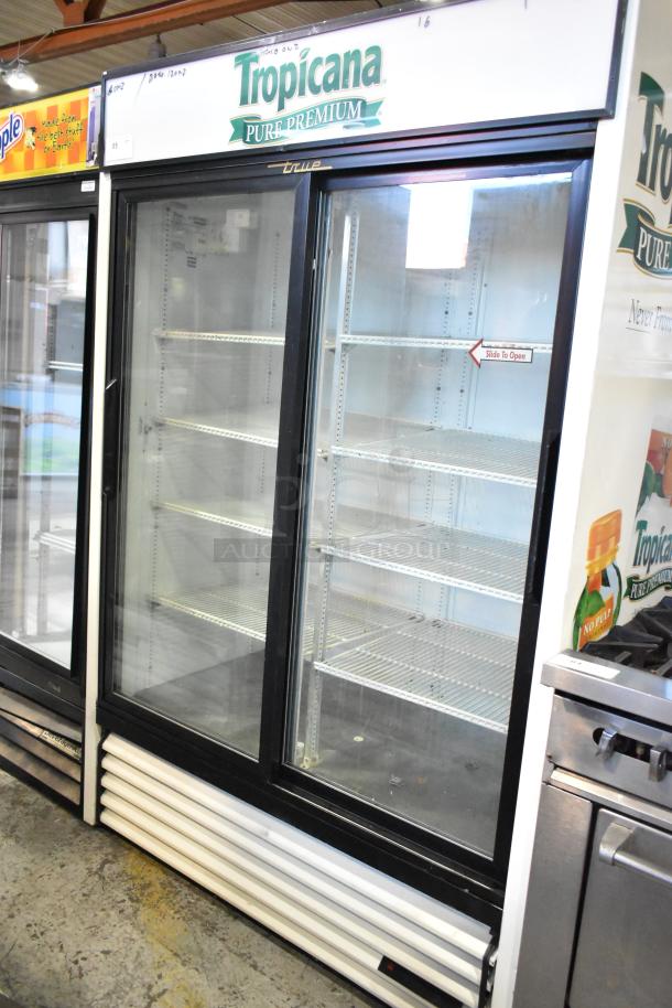 True GDM-45 commercial 2-door reach-in cooler merchandiser, features Tropicana branding. 115 volts, good condition.