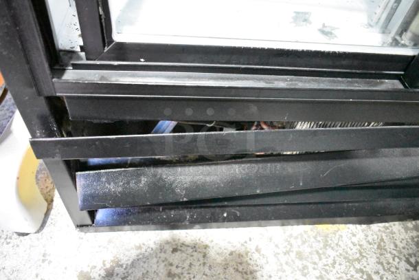 Beverage Air MT38 cooler base, showing black metal trim and lower panel detail, minor wear visible.