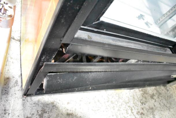 Beverage Air MT38 cooler door close-up, showing black frame and glass. Commercial use, 115 volts, 1 phase.