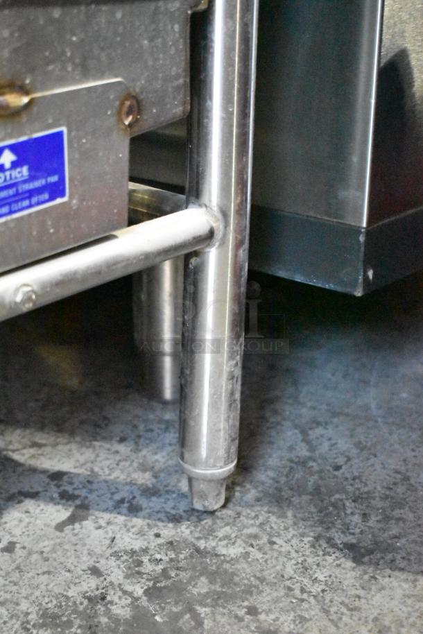 Ecolab ES-2000 commercial dishwasher leg detail, stainless steel, visible blue label, excellent condition.