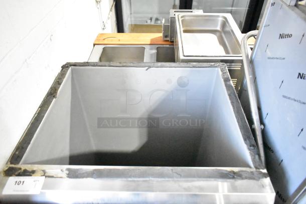 Scotsman Commercial Ice Bin, stainless steel, open top view, industrial setting, slight wear, marked "Nitto."