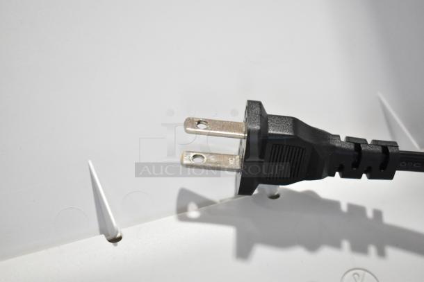 Power plug of Epson ET-3850 scanner copier printer, 120 volts, 1 phase, black cord, placed on a white surface.