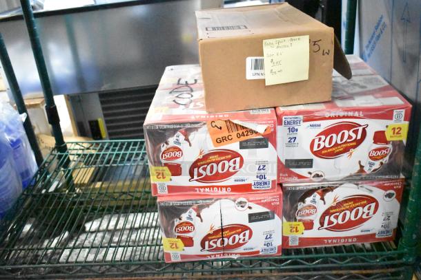 Two-tier lot featuring Boost drinks and a box labeled "Easy Spirit Ballet Flats, Size 8.5." Boost pack shows 12 bottles.