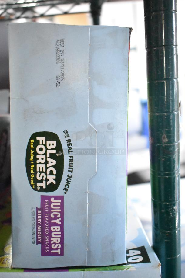 Box of Black Forest Juicy Burst fruit snacks, berry medley flavor, made with real fruit juice. Expiry: 03/21/2025.