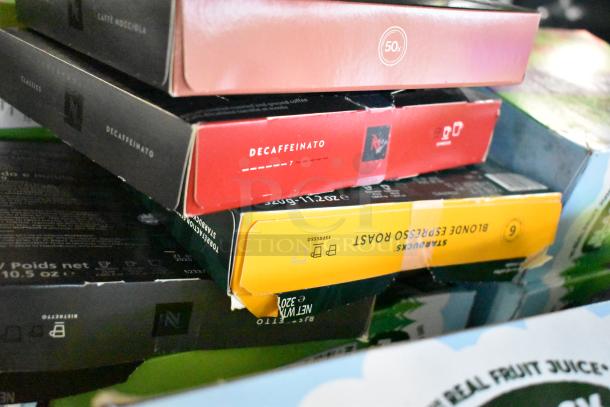 Assorted coffee pod boxes including Decaffeinato and Starbucks Blonde Espresso Roast in a tiered lot.
