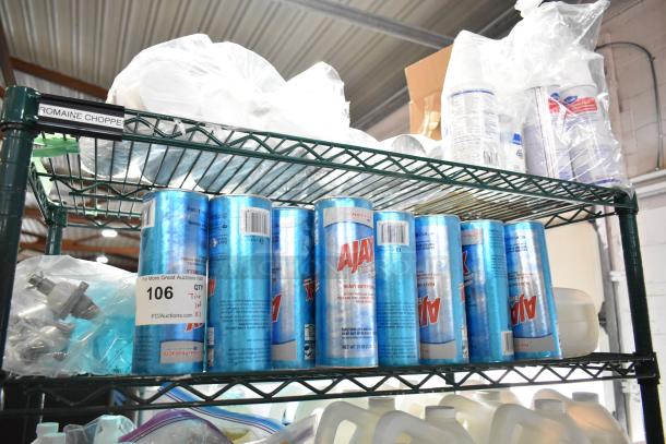 Three-tier shelf with Ajax Heavy Duty Formula cleaner cans and Diversey Oxivir sanitizer bottles, auction lot number 106 visible.