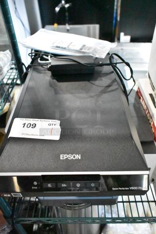 Epson Perfection V600 Photo Flatbed Scanner, black, with power cord. Auction tag labeled "109 QTY" on top.