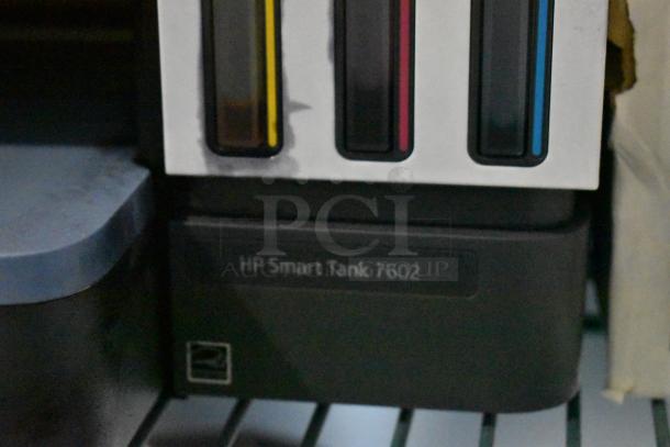 HP Smart Tank 7602 printer with visible ink tanks, label shows model number. Countertop scanner, copier, printer, 120V.