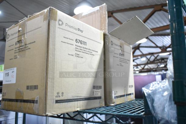 Two boxes of PremierPro 676111 Disposable Underpads, 30x36 inch, new in box, marked heavy absorbency, 5 bags per box.