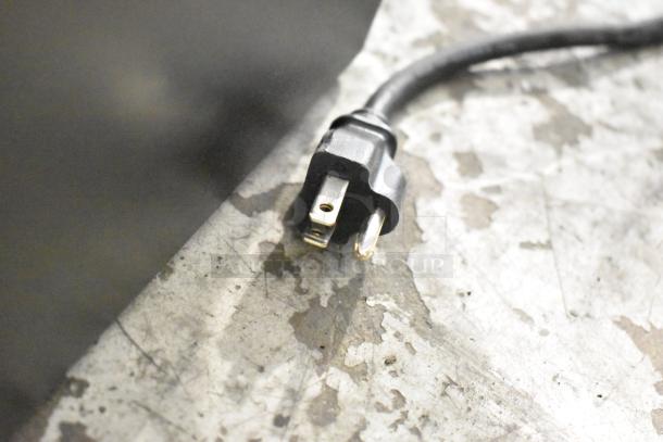 Power cord for Keurig Single Cup Coffee Machine, 120 volts, 1 phase plug, viewed on a textured surface.