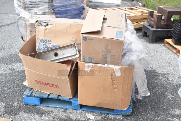 Cardboard boxes with Dixie Ultra 32006 labeling, containing various brand new scratch and dent items, on a pallet.