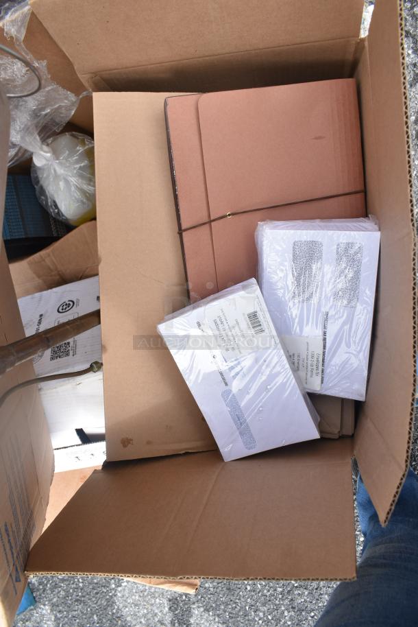 Cardboard box with 15 scratch and dent items including Dixie Ultra 32006, cleaner, Purell foam soap, wrapped in plastic. New condition.