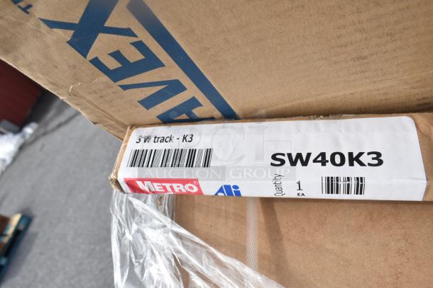 Brand new Metro SW40K3 SmartWall wall track in packaging, part of a 31-item auction lot. Label indicates model number and quantity.