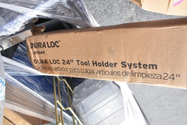 Cardboard box labeled "DuraLoc 24'' Tool Holder System" on plastic-wrapped items, showing new, scratch and dent condition.