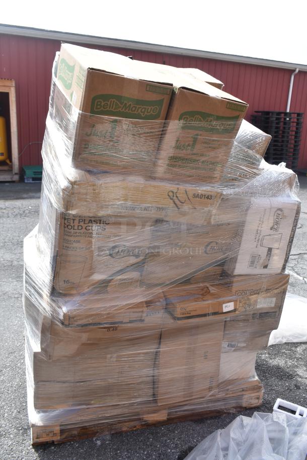 Pallet of new scratch and dent items including napkins, towels, plastic cold cups, wrapped in plastic, Bell-Marquik visible.