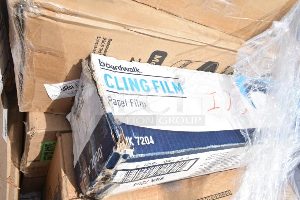 Boxes of Boardwalk Cling Film and other items, labeled as scratch and dent. Includes trash bags and hot cups.