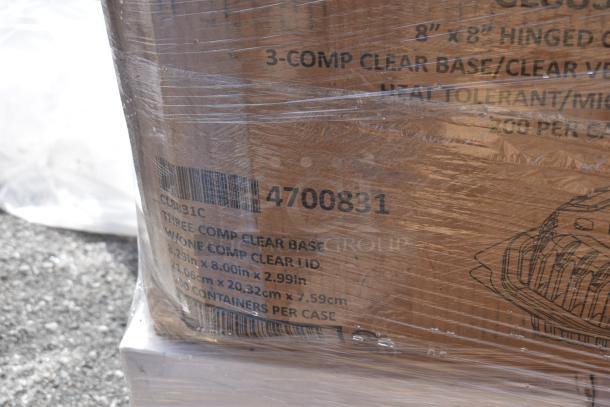 Plastic-wrapped boxes labeled "Three Comp Clear Base," showcasing items in scratch and dent condition, barcode showing.