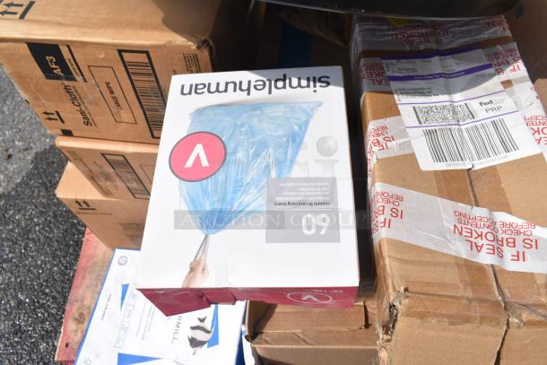 Boxes of 24 brand new scratch and dent items, including Sani-Cloth Large Wipes and Health Guards KL260, stacked for auction.