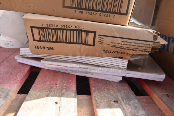Cardboard boxes containing 24 new scratch and dent items, including Health Guards KL260, on a pallet. Packaging shows barcodes.