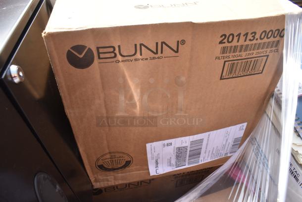 Cardboard box labeled "BUNN" with a visible shipment label. Contains 20 new scratch and dent items including office supplies.
