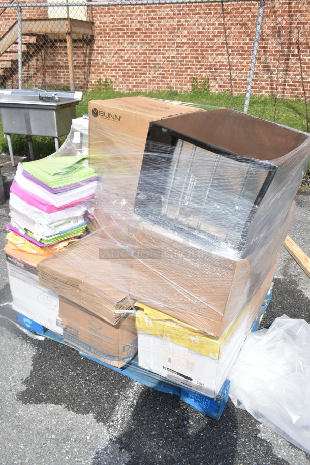 20 new scratch and dent items on a pallet, including a filing cabinet, colorful paper reams, and Zebra label printers.