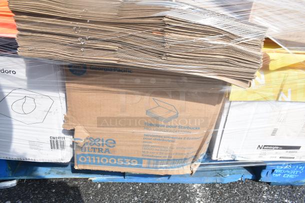 Pallet of scratch and dent items, including paper reams, cardboard boxes, and packaging; partially covered in plastic wrap.