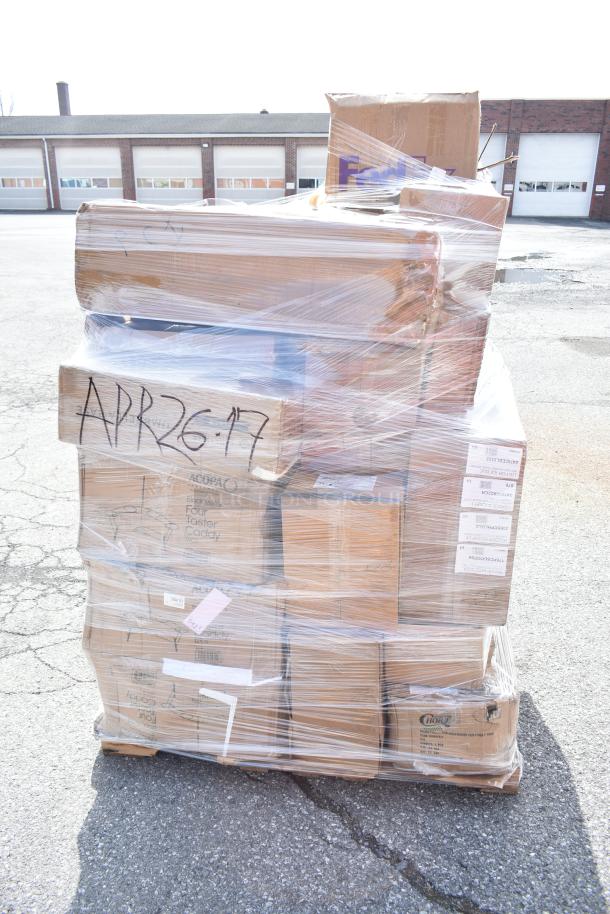 Pallet of 29 scratch and dent items, including a burger press and sheet pans, wrapped in plastic. Boxes marked APR26-17.