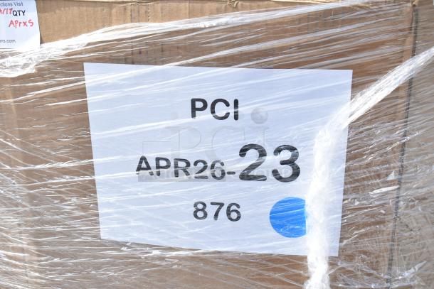 Cardboard box wrapped in plastic showing label "PCI APR26-23 876," containing new scratch and dent items, including chairs.