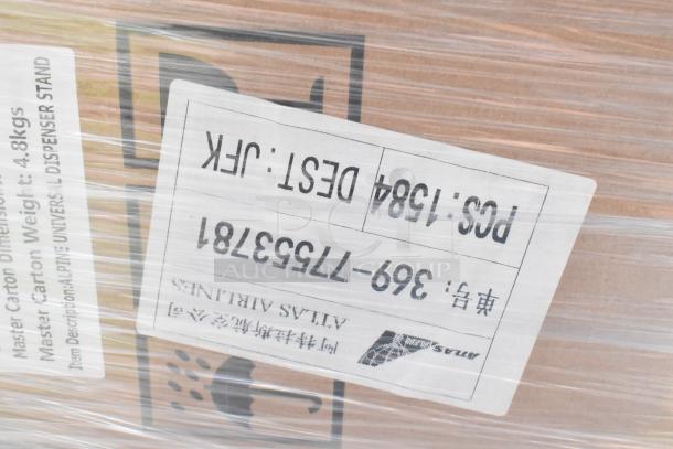 Plastic-wrapped box labeled “Atlas Airlines.” Contains new Alpine ALP430-STAND-BLK sanitizer and soap dispenser stands.